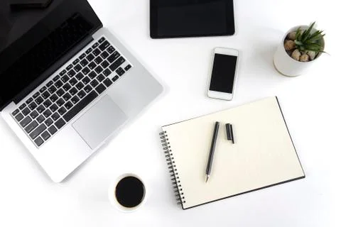Office table with laptop computer, notebook, digital tablet and smartphone on Stock Photos