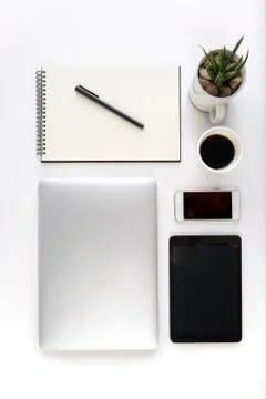 Office table with laptop computer, notebook, digital tablet and smartphone on Stock Photos