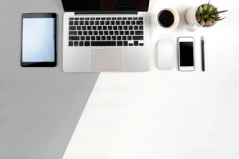 Office table with  laptop computer, notebook, digital tablet and smartphone o Stock Photos
