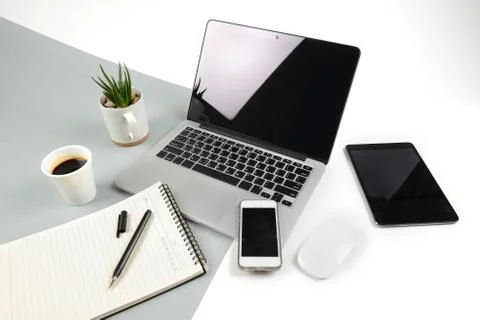 Office table with  laptop computer, notebook, digital tablet and smartphone o Stock Photos