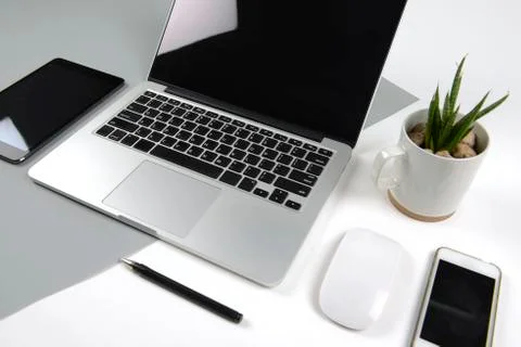 Office table with  laptop computer, notebook, digital tablet and smartphone o Stock Photos