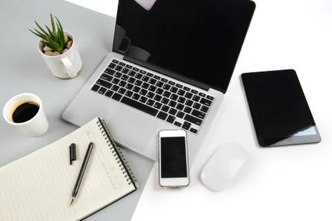 Office table with  laptop computer, notebook, digital tablet and smartphone o Stock Photos