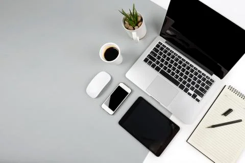 Office table with  laptop computer, notebook, digital tablet and smartphone o Stock Photos