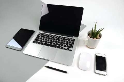 Office table with  laptop computer, notebook, digital tablet and smartphone o Stock Photos