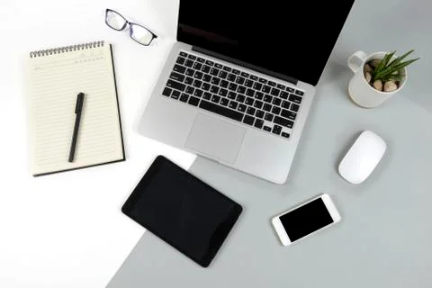 Office table with laptop computer, notebook, digital tablet and mobile phone  Stock Photos