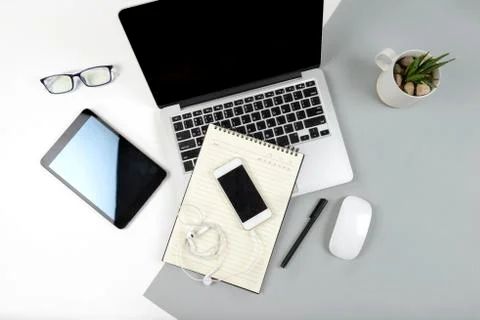 Office table with laptop computer, notebook, digital tablet and mobile phone  Stock Photos