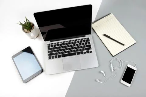 Office table with laptop computer, notebook, digital tablet and mobile phone  Stock Photos