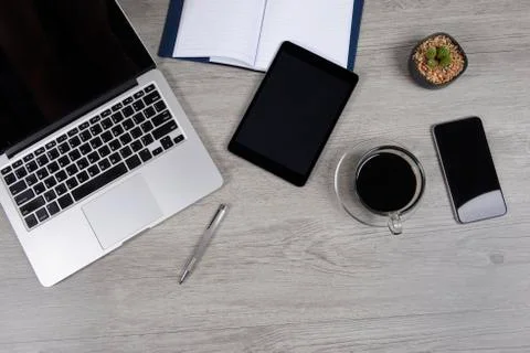 Office table with laptop computer, notebook, digital tablet, pen, smartphone, Stock Photos