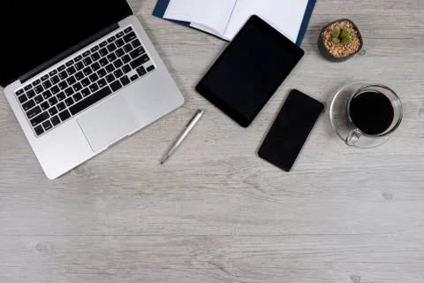 Office table with laptop computer, notebook, digital tablet, pen, smartphone, Stock Photos