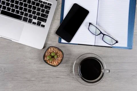 Office table with laptop computer, notebook, digital tablet, smartphone, mous Stock Photos