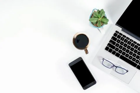 Office table with laptop computer, smartphone, pen, notebook and coffee on is Stock Photos