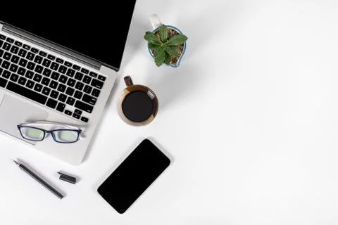 Office table with laptop computer, smartphone, pen, notebook and coffee on is Stock Photos