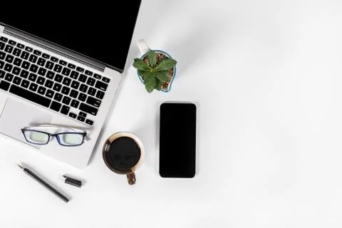 Office table with laptop computer, smartphone, pen, notebook and coffee on is Stock Photos