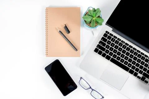Office table with laptop computer, smartphone, pen, notebook and coffee on is Stock Photos