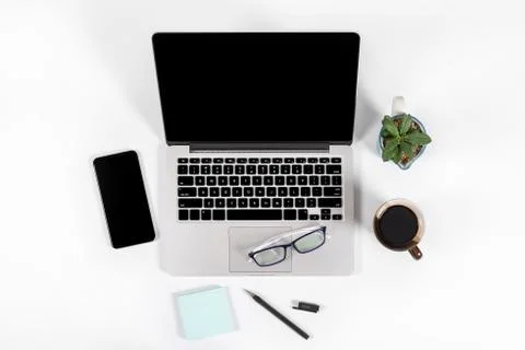 Office table with laptop computer, smartphone, pen, notebook and coffee on is Stock Photos