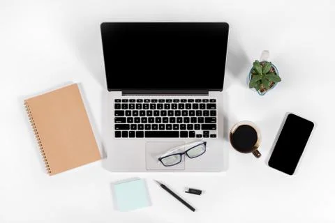 Office table with laptop computer, smartphone, pen, notebook and coffee on is Stock Photos
