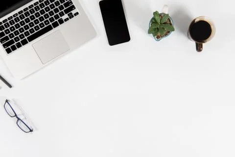 Office table with laptop computer, smartphone, pen, notebook and coffee on is Stock Photos