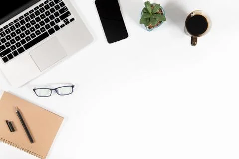 Office table with laptop computer, smartphone, pen, notebook and coffee on is Stock Photos