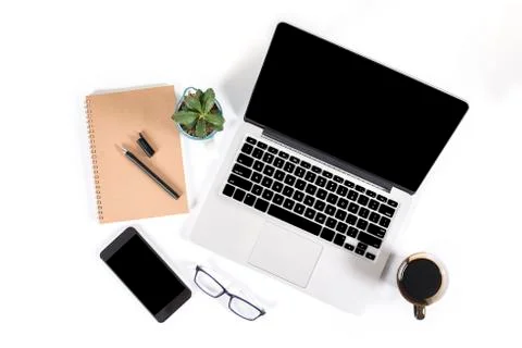 Office table with laptop computer, smartphone, pen, notebook and coffee on is Stock Photos