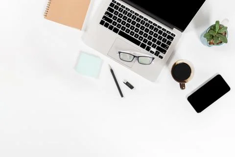 Office table with laptop computer, smartphone, pen, notebook and coffee on is Stock Photos