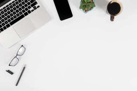 Office table with laptop computer, smartphone, pen, notebook and coffee on is Stock Photos