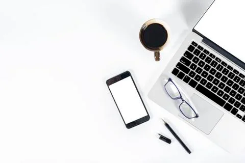Office table with laptop computer, smartphone, pen, notebook and coffee on is Stock Photos