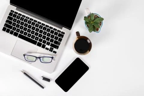 Office table with laptop computer, smartphone, pen, notebook and coffee on is Stock Photos