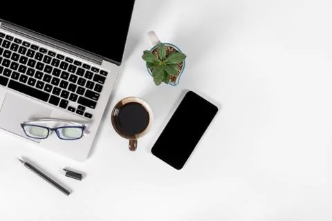 Office table with laptop computer, smartphone, pen, notebook and coffee on is Stock Photos