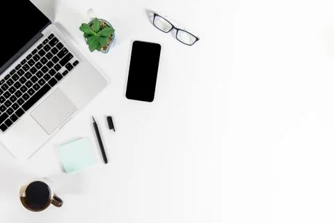 Office table with laptop computer, smartphone, pen, notebook and coffee on is Stock Photos