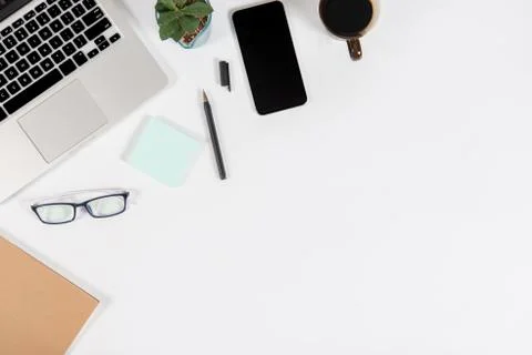 Office table with laptop computer, smartphone, pen, notebook and coffee on is Stock Photos