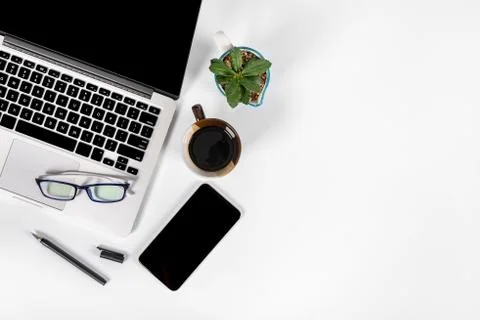 Office table with laptop computer, smartphone, pen, notebook and coffee on is Stock Photos