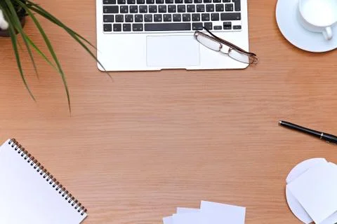 Office table with laptop, notepad and coffee cup. View from above with copy Stockfoto's