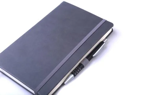 Office table with notebook and pen. copy space. Stock Photos