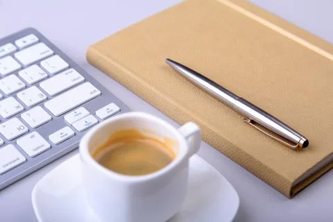Office table with notebook, computer keyboard,, cup of coffee, tablet pc. copy Stock Photos