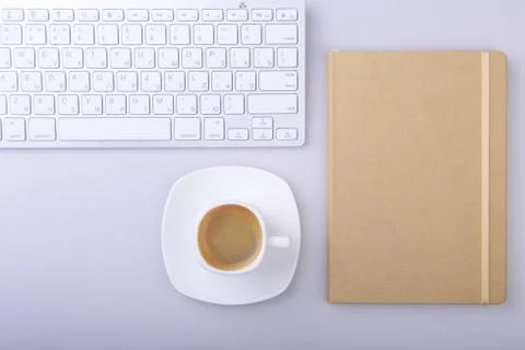 Office table with notebook, computer keyboard,, cup of coffee, tablet pc. copy Stock Photos