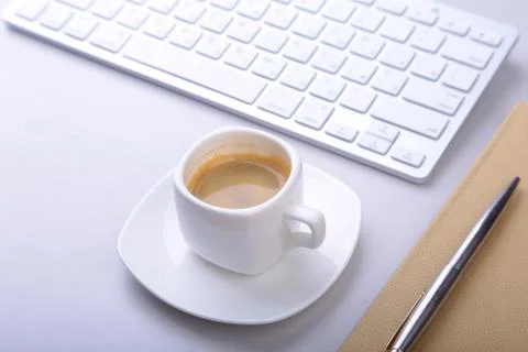 Office table with notebook, computer keyboard,, cup of coffee, tablet pc. copy Stock Photos
