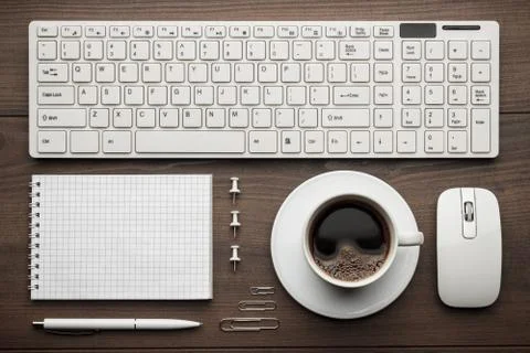 Office table with notepad, computer and coffee cup Stock Photos