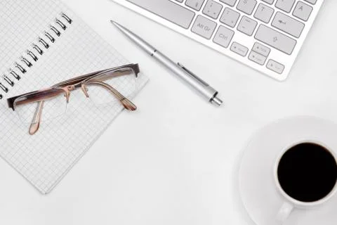 Office table with notepad, computer and coffee cup Stock Photos