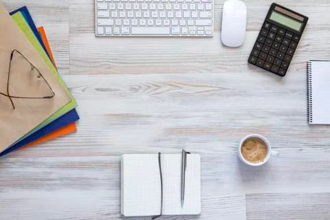 Office table with notepad, computer, pen and tea cup Stock Photos