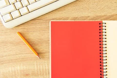 Office table pattern notebook white and red paper pencil and desktop computer 스톡 사진