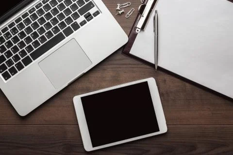 Office table with tablet, notepad and computer Stock Photos