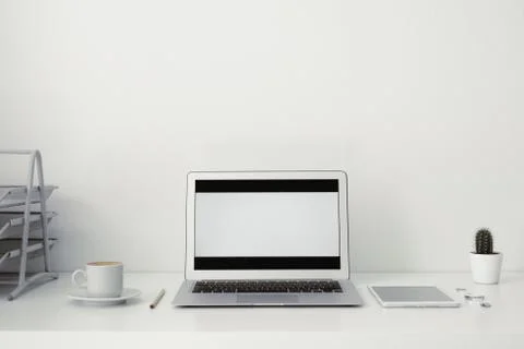 Office table on which laptop, coffee, tablet, camera and other items Stock Photos