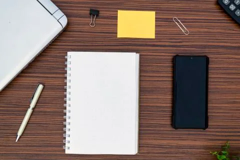 An office table working enviroment. Notepad, sticky note, pen plant, calculat Stock Photos