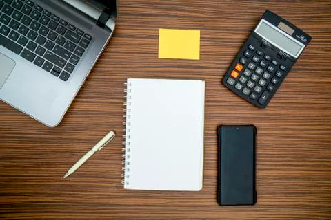 An office table working enviroment. Notepad, sticky note, pen plant, calculat Stock Photos