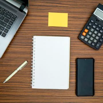 An office table working enviroment. Notepad, sticky note, pen plant, calculat Stock Photos