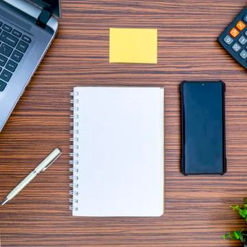 An office table working enviroment. Notepad, sticky note, pen plant, calculat Stock Photos