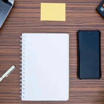 An office table working enviroment. Notepad, sticky note, pen plant, calculat Stock Photos