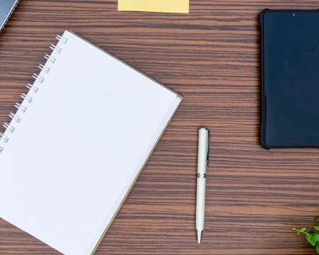 An office table working enviroment. Notepad, sticky note, pen plant, calculat Stock Photos