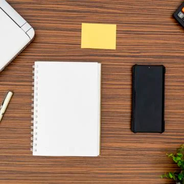 An office table working enviroment. Notepad, sticky note, pen plant, calculat Stock Photos