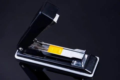 Office tacker opened with tacker staples with yellow plastic Stock Photos
